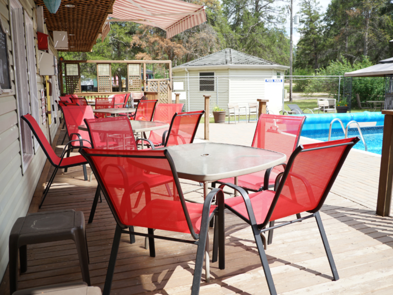 Patio chairs and tables along the pool patio.